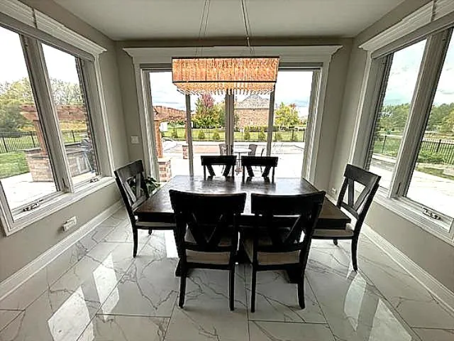 a view of a dining room with furniture window and outside view