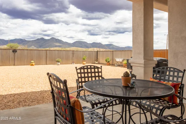 a dining table and chairs with the view of city
