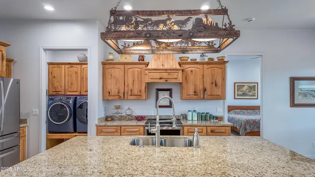 a kitchen with stainless steel appliances granite countertop a stove and cabinets