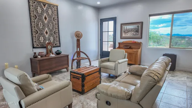 a living room with furniture a flat screen tv and a window