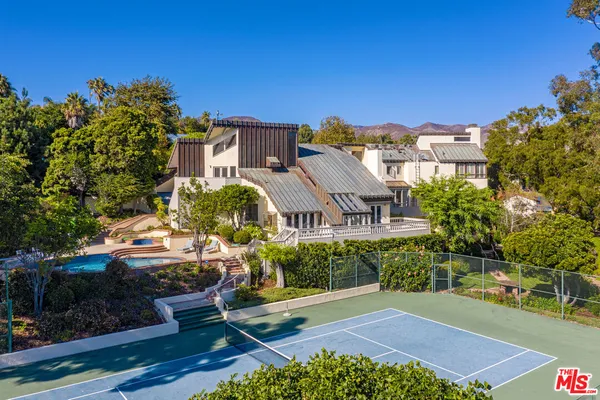 an aerial view of a house with a yard