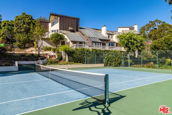 a view of a building with a swimming pool and a yard