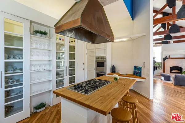 a bedroom with a bed and a wooden floor