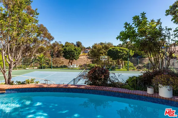 a view of yard with swimming pool and green space