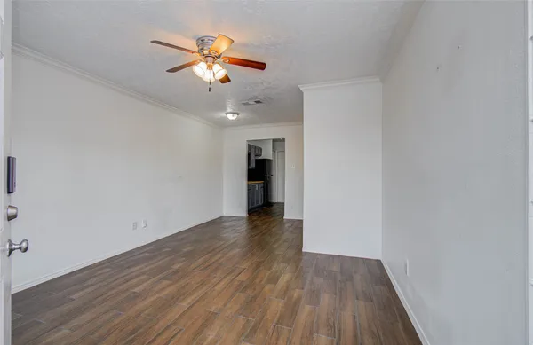a view of empty room with wooden floor