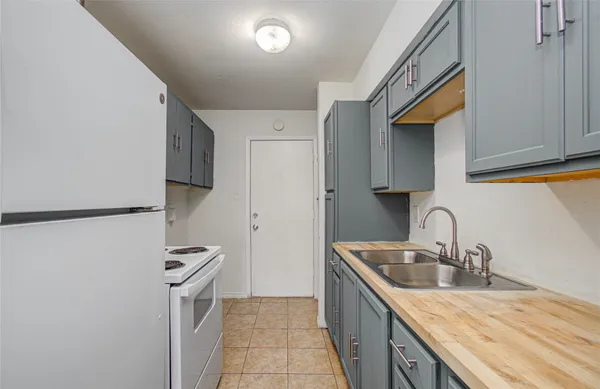 an empty room with closet and a chandelier fan