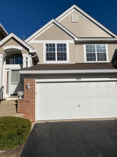 103 Bay Drive Itasca, IL 60143 - Photo 2 of 12 a front view of a house with a garage
