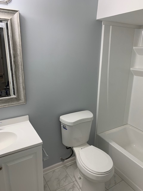 103 Bay Drive Itasca, IL 60143 - Photo 9 of 12 a white toilet sitting next to a bath tub