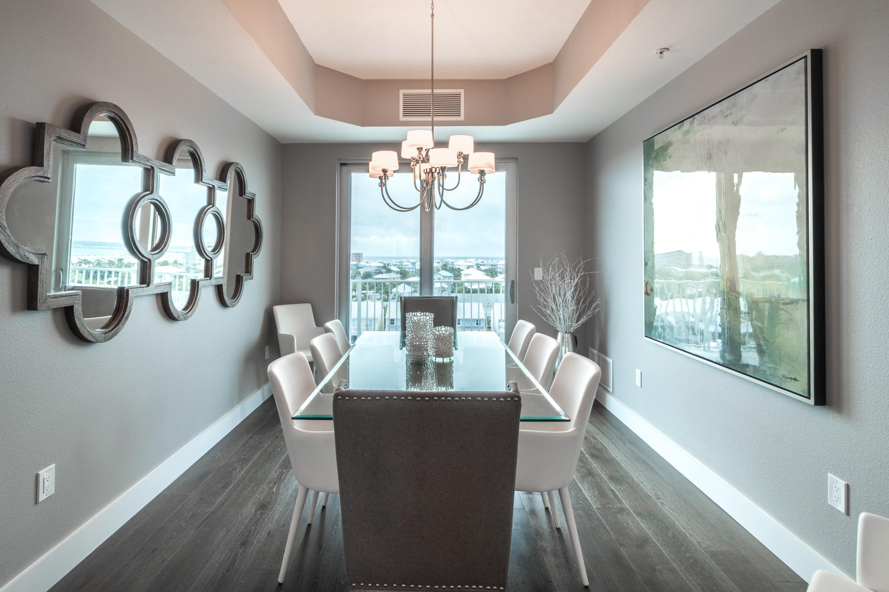 211 Durango Road, Unit 617 Destin, FL 32541 - Photo 21 of 56 a dining room with wooden floor a chandelier a glass table and chairs