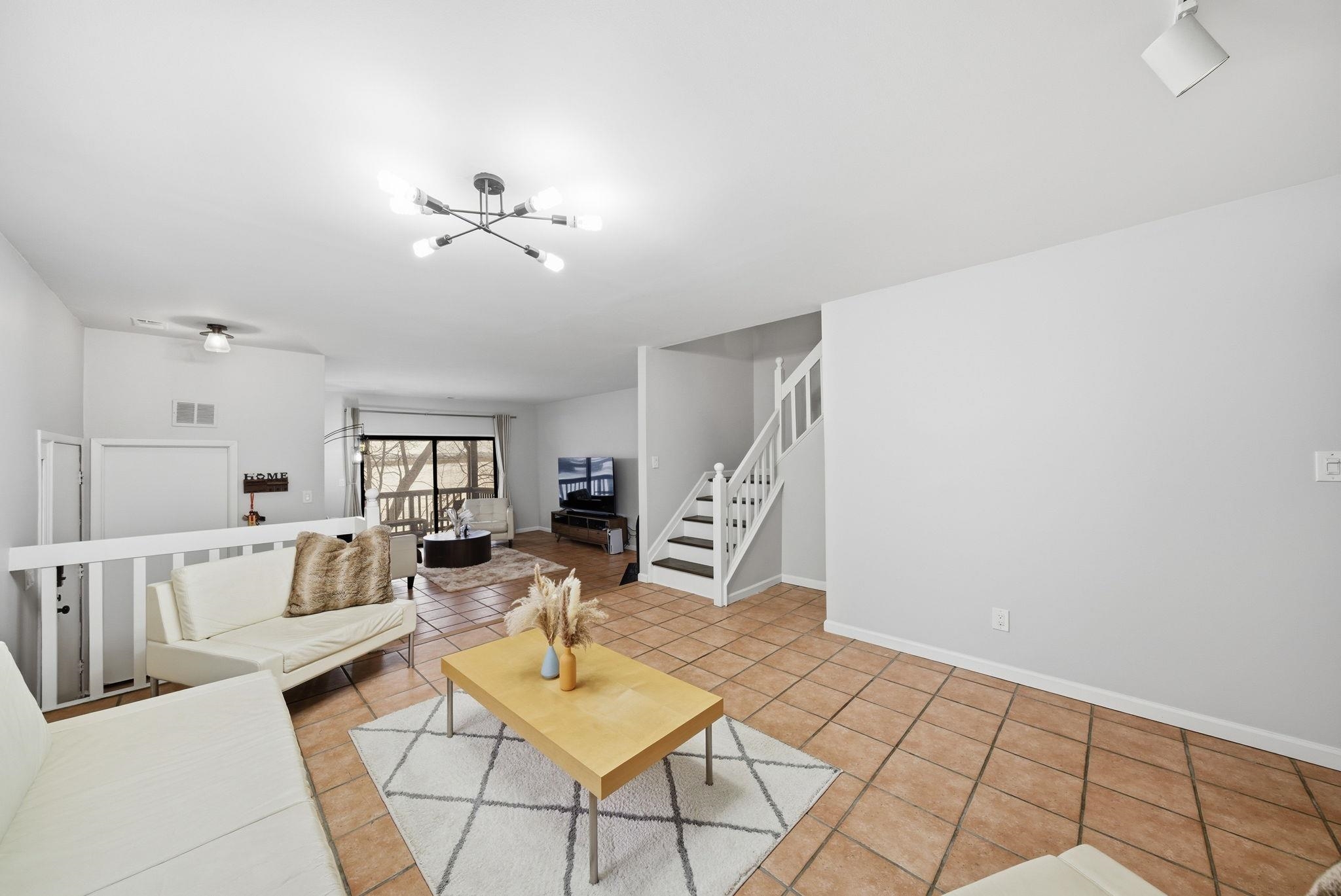 274 Sunset Key, Unit 274 Secaucus, NJ 07094 - Photo 11 of 50 a living room with furniture and a chandelier