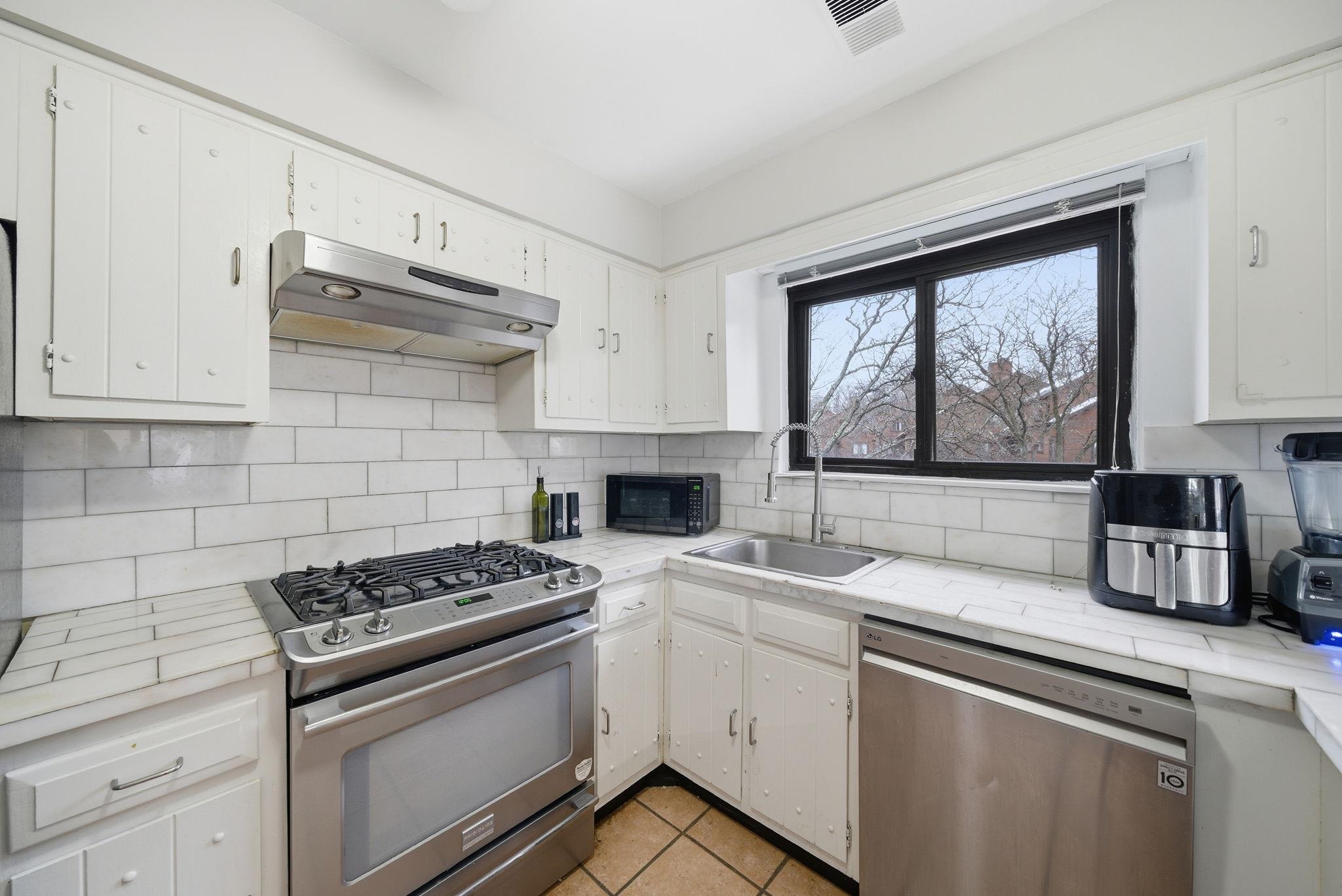274 Sunset Key, Unit 274 Secaucus, NJ 07094 - Photo 15 of 50 a kitchen with granite countertop a sink stainless steel appliances and cabinets
