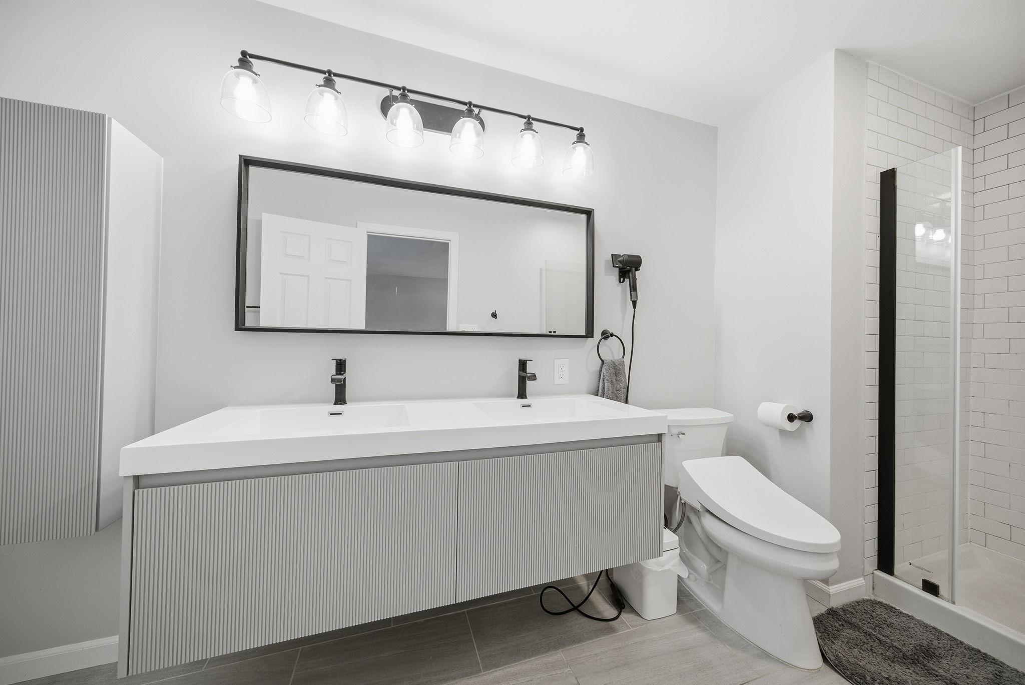 274 Sunset Key, Unit 274 Secaucus, NJ 07094 - Photo 24 of 50 a bathroom with a toilet a sink and mirror