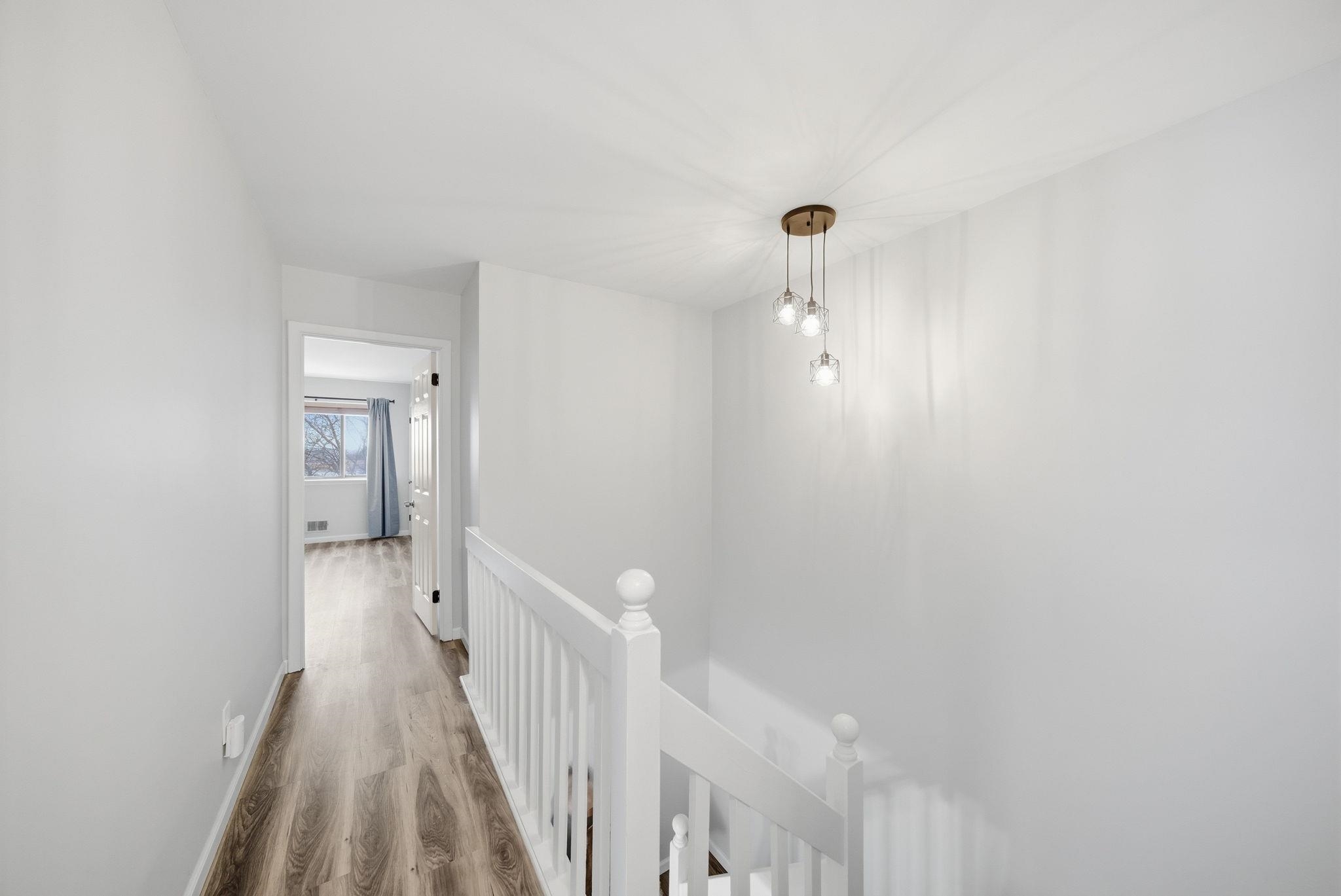 274 Sunset Key, Unit 274 Secaucus, NJ 07094 - Photo 34 of 50 a view of a hallway with wooden floor and a bathroom