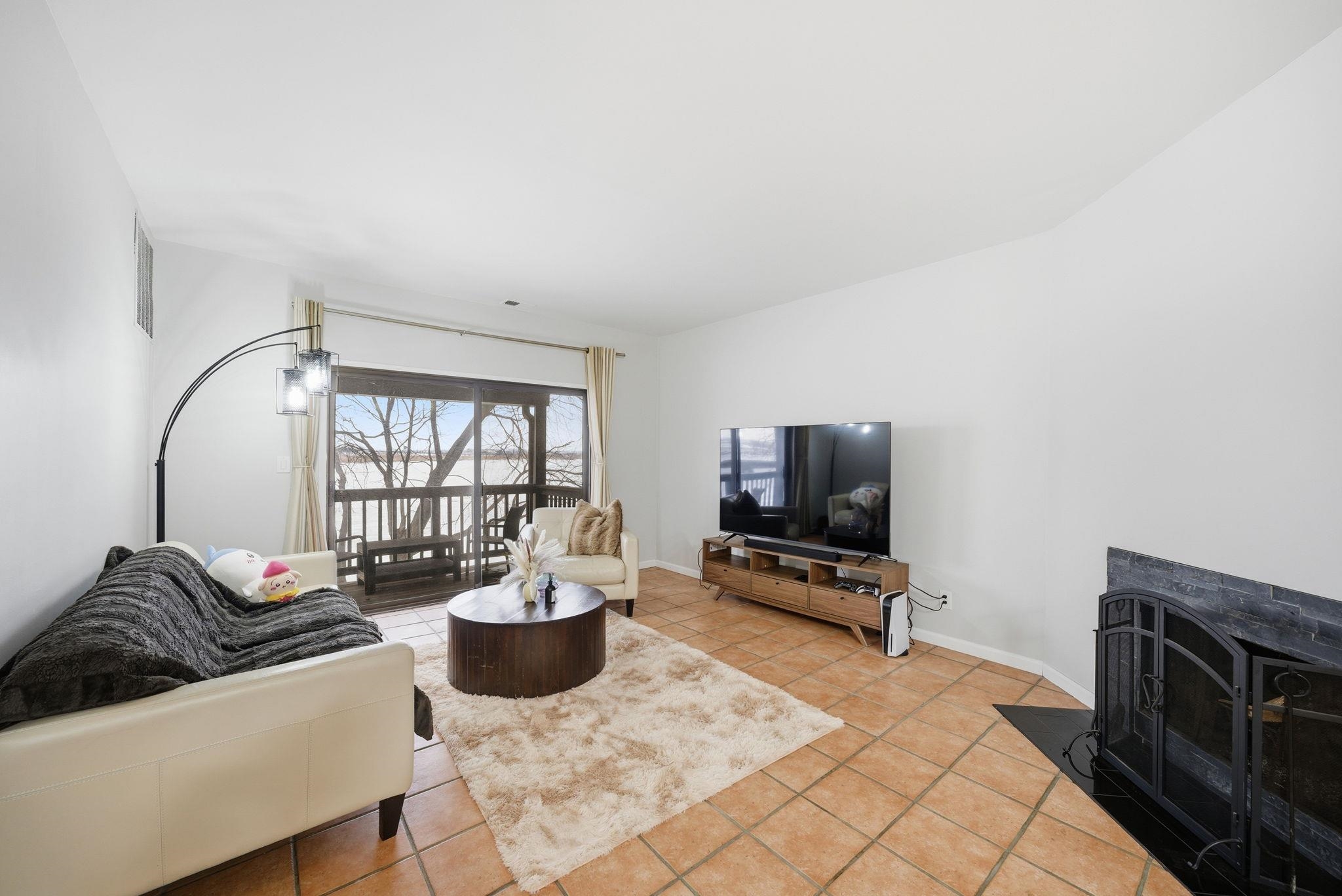 274 Sunset Key, Unit 274 Secaucus, NJ 07094 - Photo 6 of 50 a living room with furniture a flat screen tv and a large window