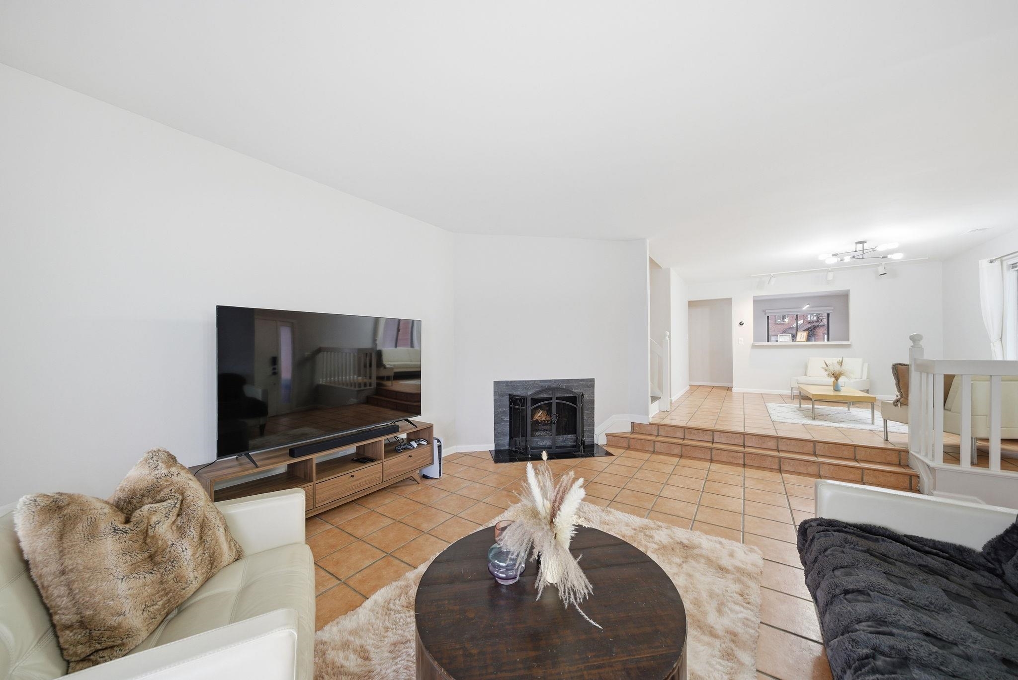 274 Sunset Key, Unit 274 Secaucus, NJ 07094 - Photo 8 of 50 a living room with furniture and a flat screen tv