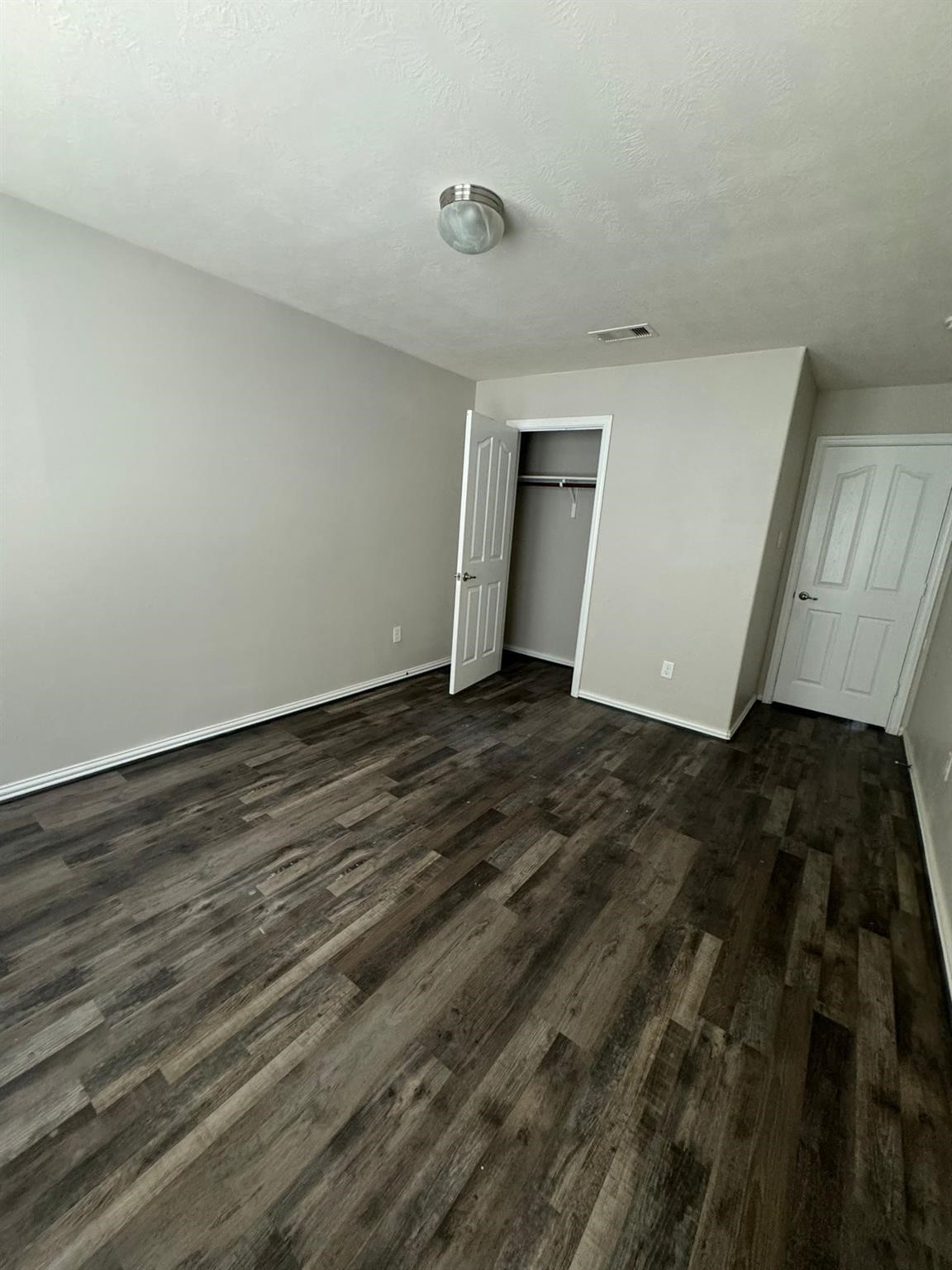 25614 Crisp Spring Lane Spring, TX 77373 - Photo 16 of 25 a view of an empty room with wooden floor and a window