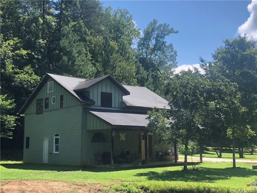 1117 Ponder Road Mill Spring, NC 28756 - Photo 3 of 39 a front view of a house with a yard and trees