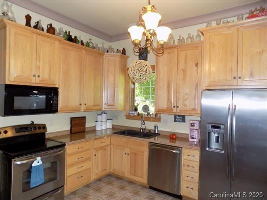 1117 Ponder Road Mill Spring, NC 28756 - Photo 6 of 39 a kitchen with stainless steel appliances a sink a stove and a refrigerator