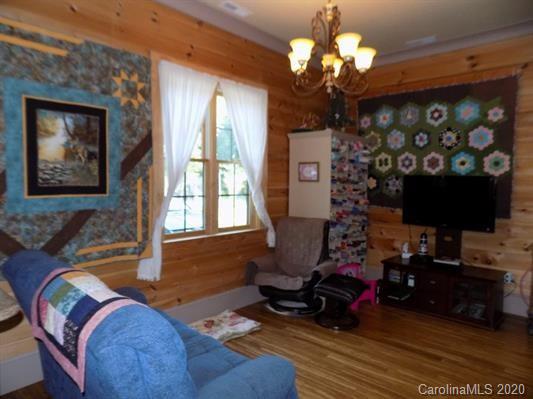 1117 Ponder Road Mill Spring, NC 28756 - Photo 10 of 39 a living room with furniture chandelier and a window
