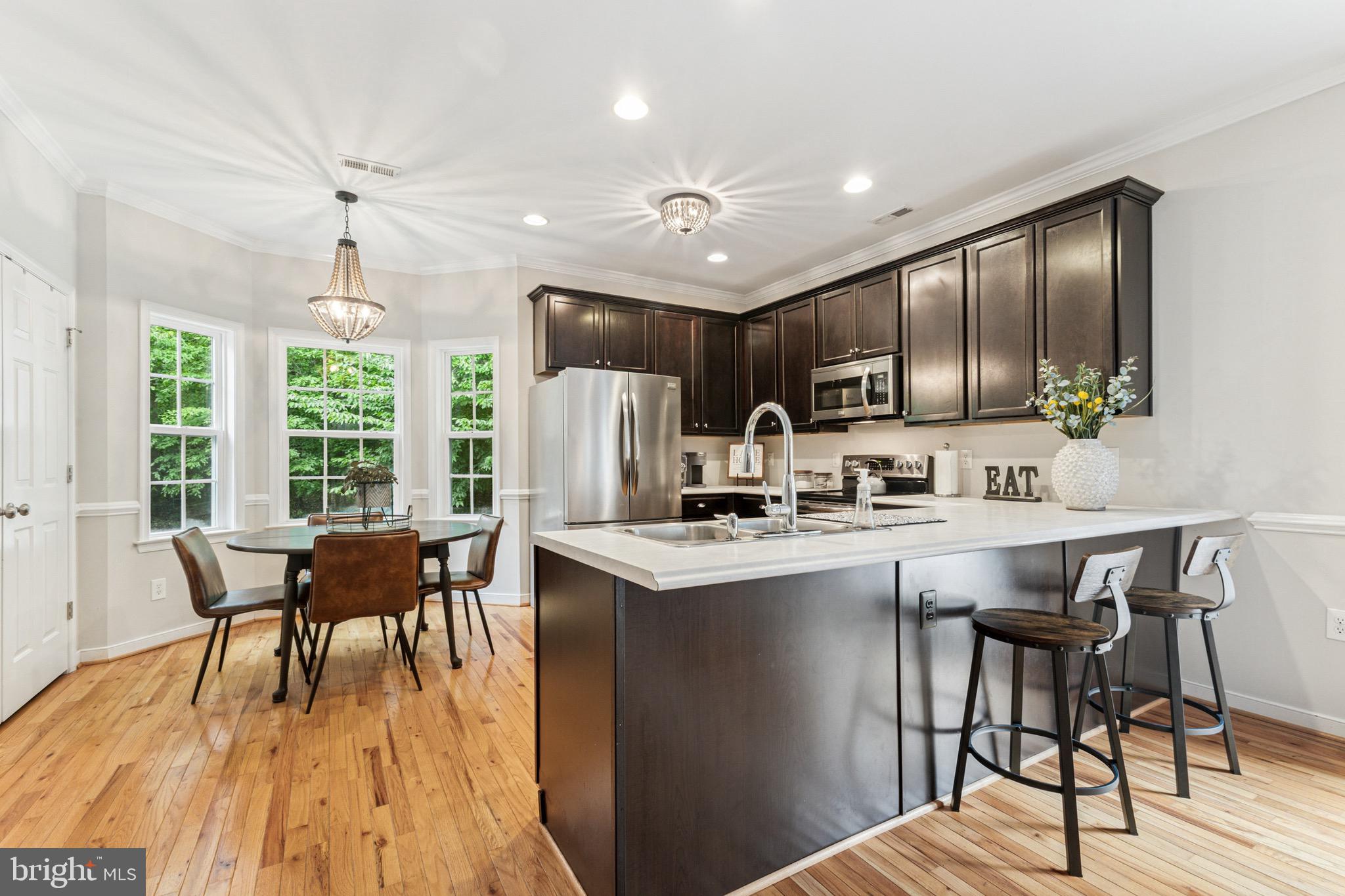 6108 Bills Road Mineral, VA 23117 - Photo 13 of 43 a kitchen with stainless steel appliances granite countertop a stove a refrigerator a kitchen island with a dining table and chairs