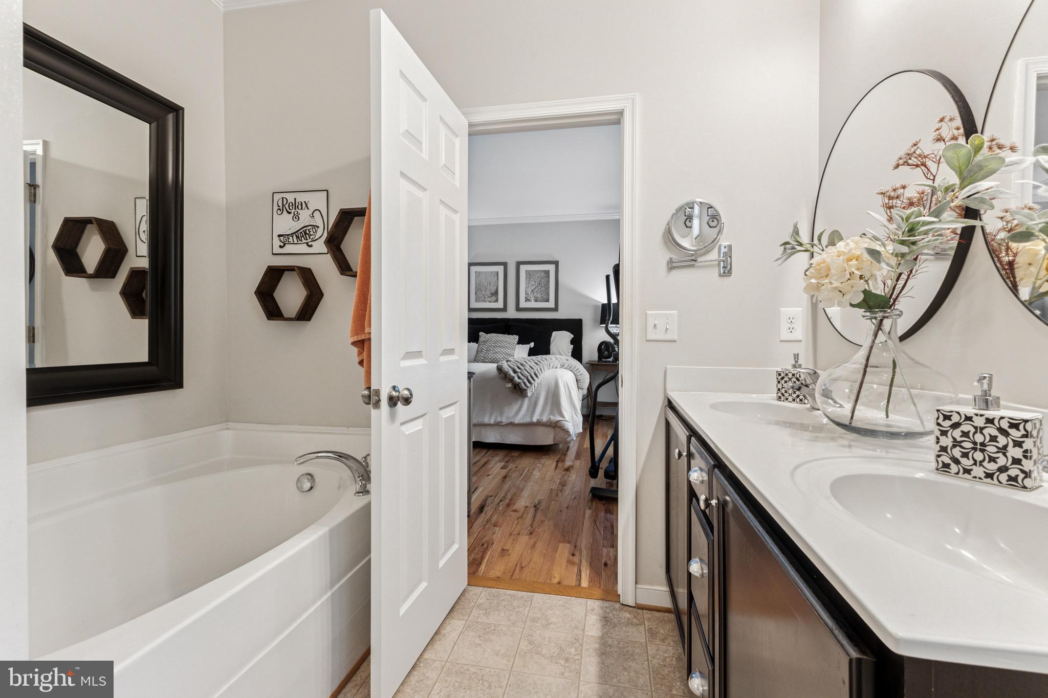 6108 Bills Road Mineral, VA 23117 - Photo 24 of 43 a en suite bathroom with a bathtub sink and mirror