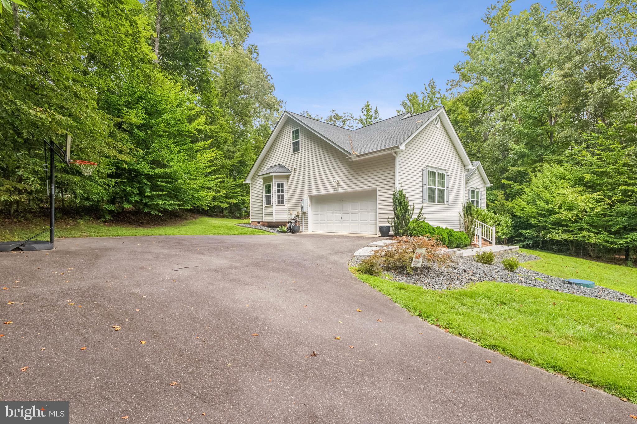 6108 Bills Road Mineral, VA 23117 - Photo 3 of 43 a view of a house with a small yard and large trees