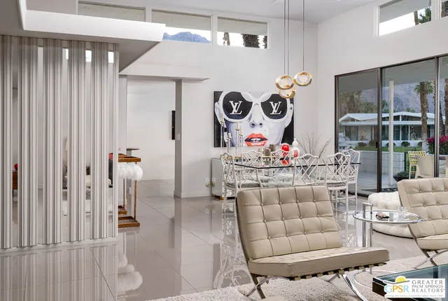 a kitchen with granite countertop cabinets a sink a dining table and chairs