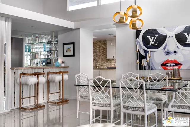 a kitchen with granite countertop white cabinets and stainless steel appliances