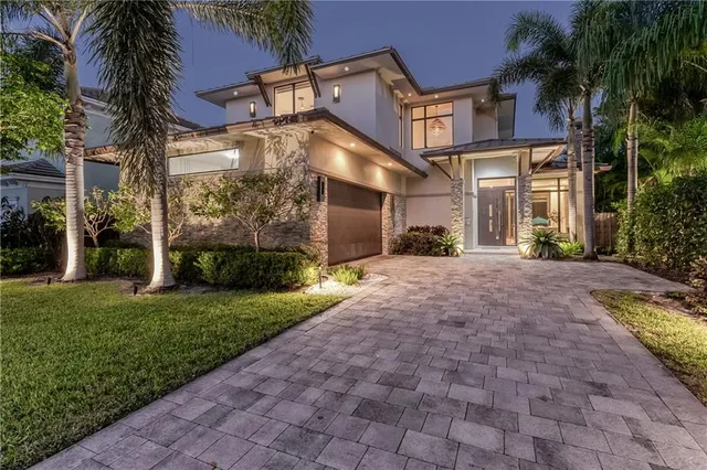 a front view of a house with a yard and a garage