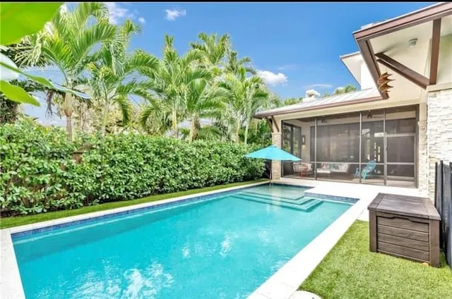 a view of a backyard with plants and a patio