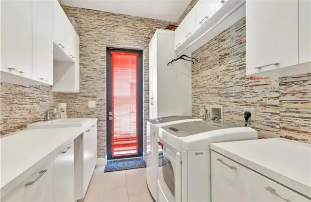 a bathroom with a sink and a washing machine