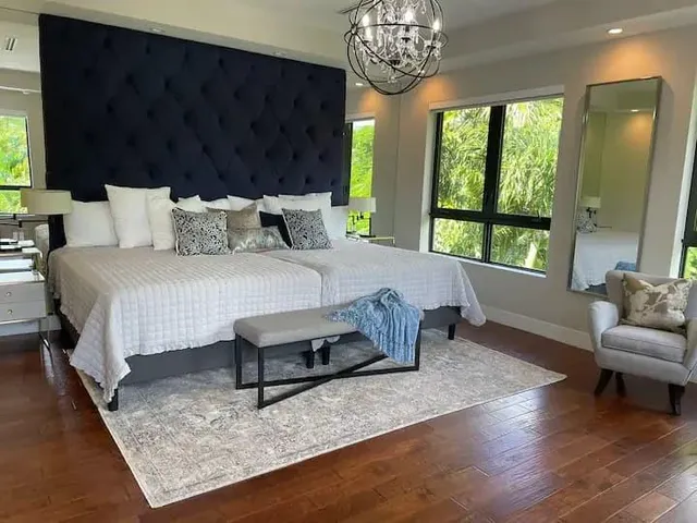 a bedroom with bed and a large window