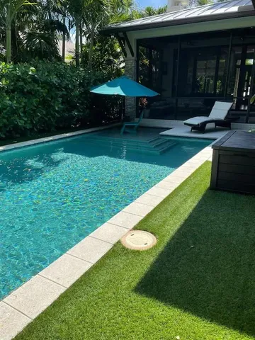 a view of a patio with a table and chairs under an umbrella
