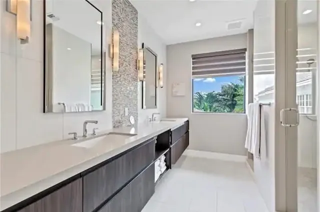 a bathroom with a double vanity sink a mirror and a bathtub