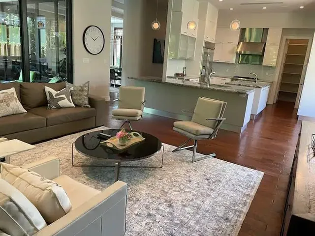 a living room with furniture and wooden floor