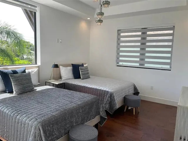 a bedroom with bed and a window