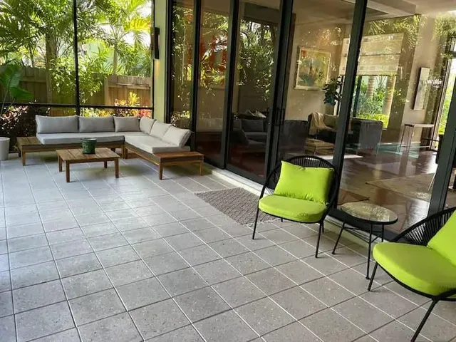 a view of a patio with a dining table and chairs