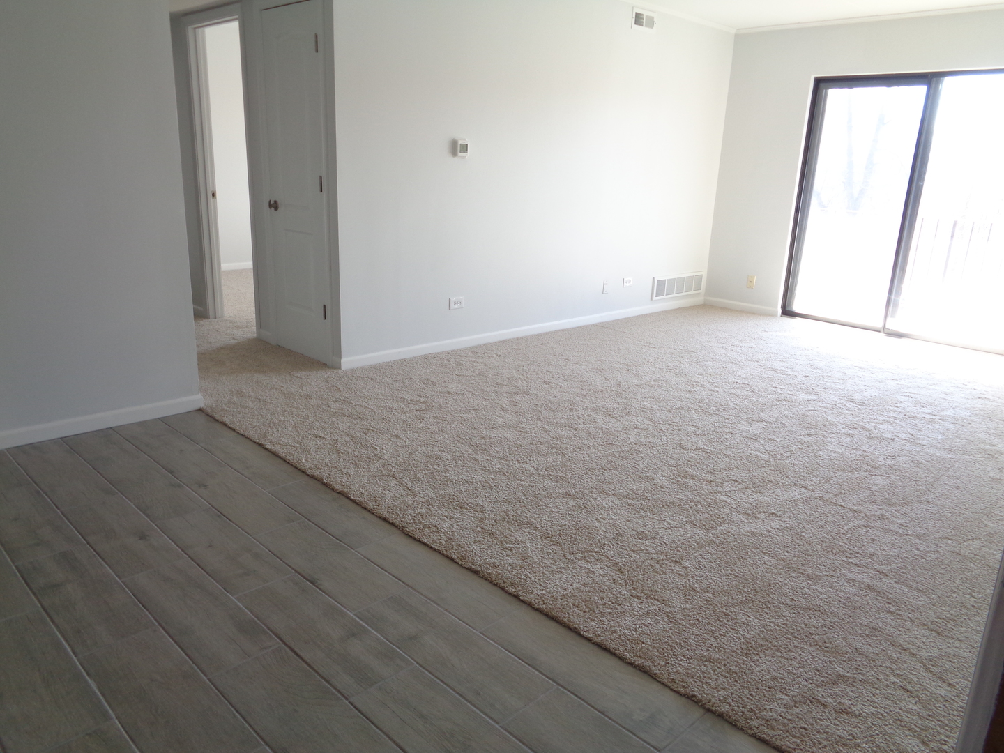 4010 150th Street, Unit 6 Midlothian, IL 60445 - Photo 3 of 13 an empty room with wooden floor and windows