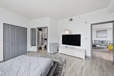 a bedroom with a bed and a flat screen tv