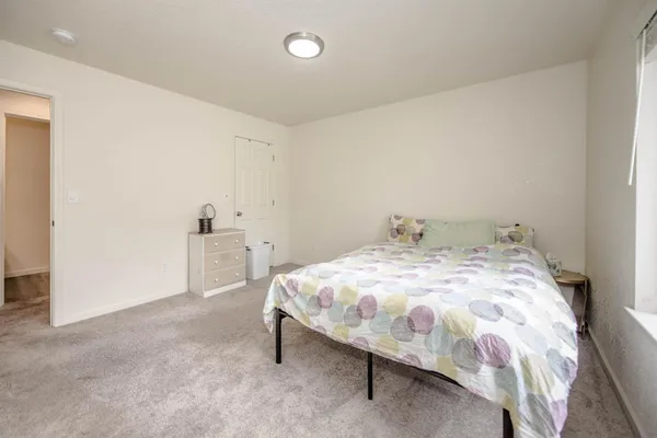 a bedroom with a bed and a wall painting