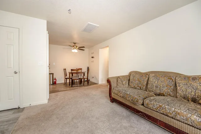 a living room with furniture and a dining table