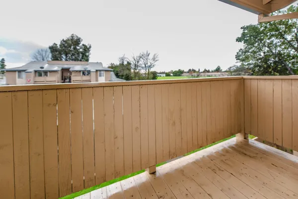 a balcony with trees in front of it