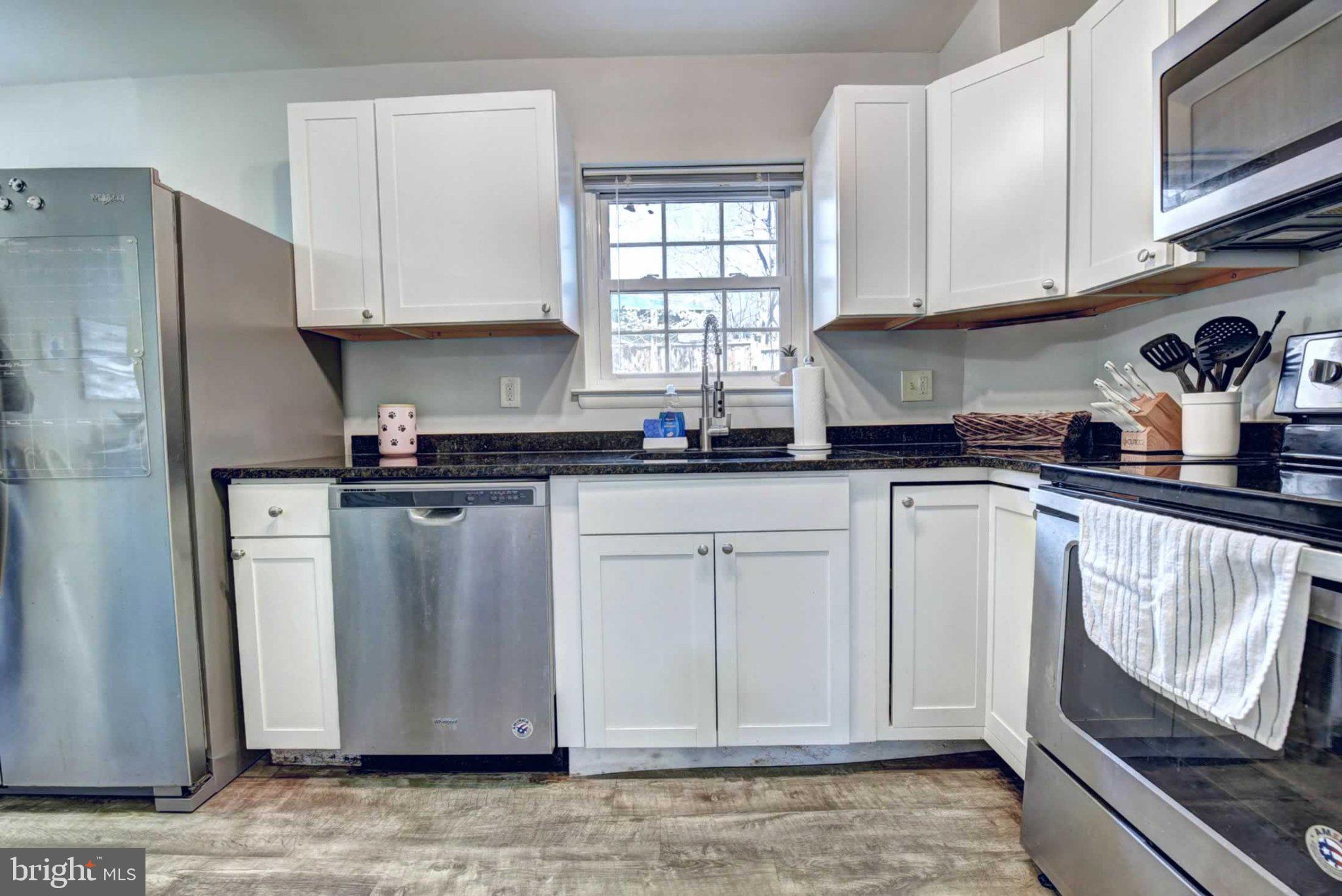 2226 Gunsmith Square Reston, VA 20191 - Photo 12 of 35 a kitchen with stainless steel appliances granite countertop a refrigerator sink and cabinets