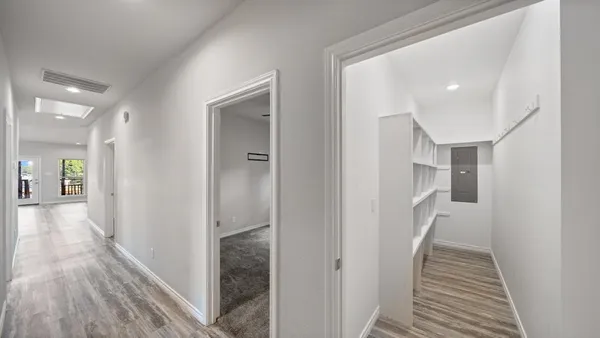 a view of hallway with wooden floor