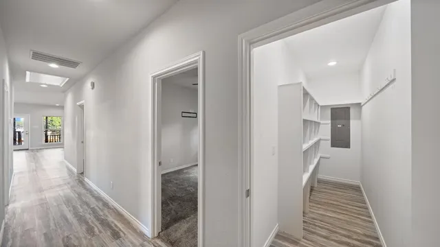 a view of hallway with wooden floor