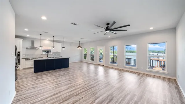 a view of a swimming pool with a bench and trees in the background