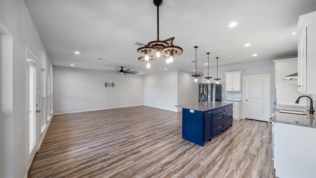 151 Sun Down Trail Mabank, TX 75156 - Photo 29 of 29 a living room with stainless steel appliances kitchen island granite countertop furniture and a wooden floor