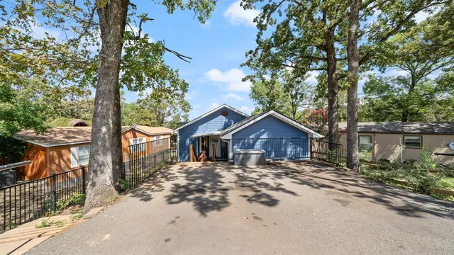 front view of a house with a tree in the background