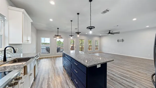 a large kitchen with lots of counter space and wooden floor