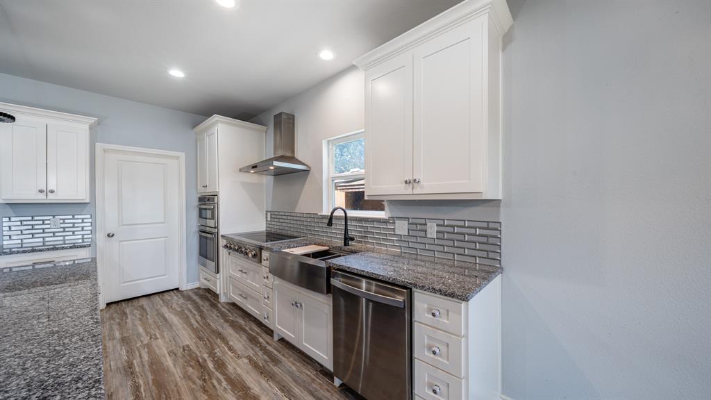 151 Sun Down Trail Mabank, TX 75156 - Photo 18 of 29 a kitchen with stainless steel appliances granite countertop a stove and a sink